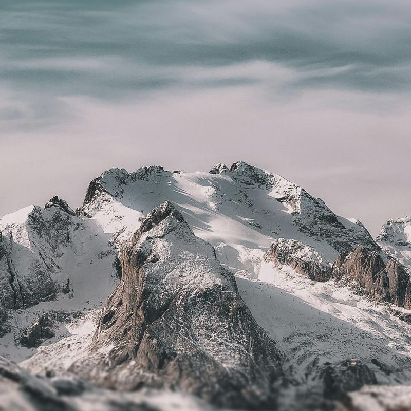 Snow-covered mountain peaks above the clouds